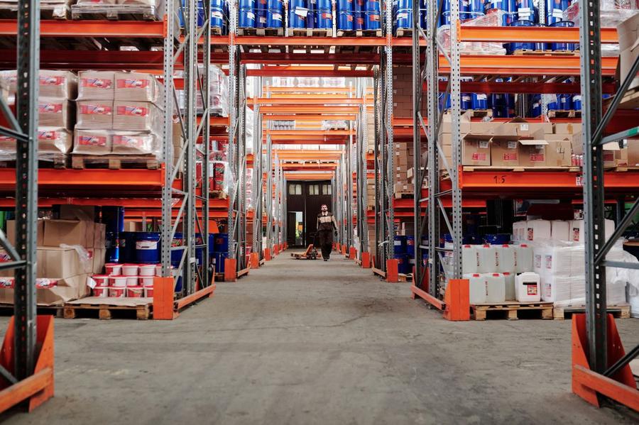 Warehouse aisle with stocked pallet racking